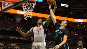 Mar 12, 2016; Charlotte, NC, USA; Houston Rockets center Dwight Howard (12) knocks the ball away from Charlotte Hornets guard Jeremy Lin (7) in the first half at Time Warner Cable Arena. Mandatory Credit: Jeremy Brevard-USA TODAY Sports