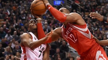 Mar 6, 2016; Toronto, Ontario, CAN; Houston Rockets center Dwight Howard (12) fouls Toronto Raptors guard Kyle Lowry (7) as they battle for a rebound in the second quarter at Air Canada Centre. Mandatory Credit: Dan Hamilton-USA TODAY Sports