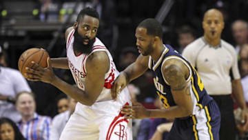 Mar 23, 2016; Houston, TX, USA; Houston Rockets guard James Harden (13) controls the ball as Utah Jazz forward Chris Johnson (23) defends during the second quarter at Toyota Center. Mandatory Credit: Troy Taormina-USA TODAY Sports