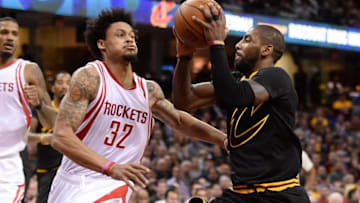 Mar 29, 2016; Cleveland, OH, USA; Cleveland Cavaliers guard Kyrie Irving (2) drives on Houston Rockets guard K.J. McDaniels (32) during the second quarter at Quicken Loans Arena. Mandatory Credit: Ken Blaze-USA TODAY Sports