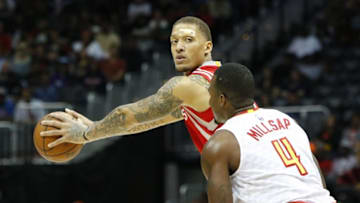 Mar 19, 2016; Atlanta, GA, USA; Houston Rockets forward Michael Beasley (8) is defended by Atlanta Hawks forward Paul Millsap (4) in the first quarter at Philips Arena. Mandatory Credit: Brett Davis-USA TODAY Sports