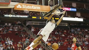 Mar 2, 2016; Houston, TX, USA; Houston Rockets forward Trevor Ariza (1) dunks against New Orleans Pelicans forward Anthony Davis (23) in the first quarter at Toyota Center. Mandatory Credit: Thomas B. Shea-USA TODAY Sports