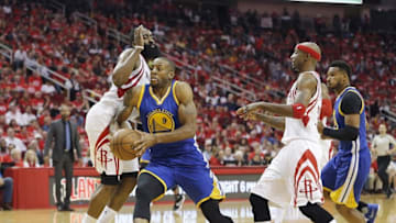 Apr 24, 2016; Houston, TX, USA; Golden State Warriors forward Andre Iguodala (9) drives against Houston Rockets guard James Harden (13) in the second half in game four of the first round of the NBA Playoffs at Toyota Center. Golden State Warriors won 121 to 94. Mandatory Credit: Thomas B. Shea-USA TODAY Sports