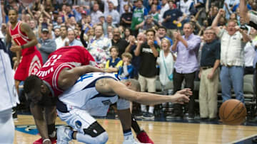 Apr 6, 2016; Dallas, TX, USA; Houston Rockets guard James Harden (13) fouls Dallas Mavericks guard Devin Harris (34) during the second half at the American Airlines Center. The Mavericks defeat the Rockets 88-86. Mandatory Credit: Jerome Miron-USA TODAY Sports