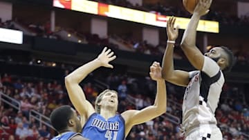 Jan 24, 2016; Houston, TX, USA; Houston Rockets guard James Harden (13) shoots against Dallas Mavericks forward Dirk Nowitzki (41) in the second quarter at Toyota Center. Mandatory Credit: Thomas B. Shea-USA TODAY Sports