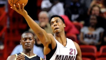 Dec 18, 2015; Miami, FL, USA; Miami Heat center Hassan Whiteside (21) reaches for the ball against Toronto Raptors center Bismack Biyombo (8) at American Airlines Arena. Mandatory Credit: Robert Duyos-USA TODAY Sports