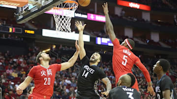 Feb 23, 2015; Houston, TX, USA; Minnesota Timberwolves center Nikola Pekovic (14) shoots against Houston Rockets forward Donatas Motiejunas (20) and forward Josh Smith (5) in the second half at Toyota Center. Rockets won 113 to 102. Mandatory Credit: Thomas B. Shea-USA TODAY Sports