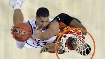 Mar 24, 2016; Louisville, KY, USA; Kansas Jayhawks forward Landen Lucas (33) shoots the ball against Maryland Terrapins forward Robert Carter (4) during the first half in a semifinal game in the South regional of the NCAA Tournament at KFC YUM!. Mandatory Credit: Jamie Rhodes-USA TODAY Sports