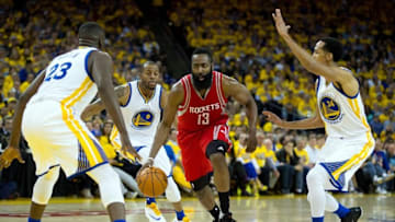 Apr 27, 2016; Oakland, CA, USA; Houston Rockets guard James Harden (13) drives in against Golden State Warriors forward Draymond Green (23), forward Andre Iguodala (9) and guard Shaun Livingston (34) during the second quarter in game five of the first round of the NBA Playoffs at Oracle Arena. Mandatory Credit: Kelley L Cox-USA TODAY Sports
