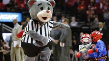 Mar 25, 2016; Houston, TX, USA; Boys dressed as Superman and Batman spar each as Houston Rockets mascot "Clutch" referees during a timeout during the Houston Rockets and Toronto Raptors basketball game at Toyota Center. Mandatory Credit: Thomas B. Shea-USA TODAY Sports