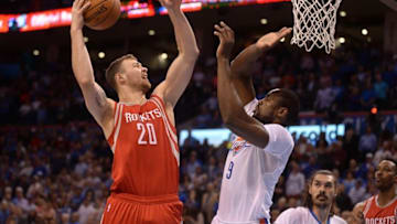 Mar 22, 2016; Oklahoma City, OK, USA; Houston Rockets forward Donatas Motiejunas (20) shoots the ball over Oklahoma City Thunder forward Serge Ibaka (9) during the first quarter at Chesapeake Energy Arena. Mandatory Credit: Mark D. Smith-USA TODAY Sports