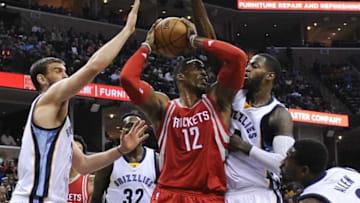 Nov 20, 2015; Memphis, TN, USA; Houston Rockets center Dwight Howard (12) handles the ball against Memphis Grizzlies forward JaMychal Green (0) and Memphis Grizzlies center Marc Gasol (33) during the second half at FedExForum. Memphis Grizzlies beat Houston Rockets 96-84. Mandatory Credit: Justin Ford-USA TODAY Sports