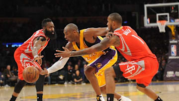 December 17, 2015; Los Angeles, CA, USA; Los Angeles Lakers forward Kobe Bryant (24) moves the ball against Houston Rockets guard James Harden (13) and forward Trevor Ariza (1) during the second half at Staples Center. Mandatory Credit: Gary A. Vasquez-USA TODAY Sports