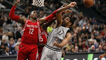 Jan 2, 2016; San Antonio, TX, USA; San Antonio Spurs power forward Tim Duncan (21) has his shot blocked by Houston Rockets center Dwight Howard (12) during the first half at AT&T Center. Mandatory Credit: Soobum Im-USA TODAY Sports