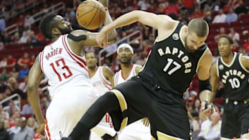 Mar 25, 2016; Houston, TX, USA; Houston Rockets guard James Harden (13) and Toronto Raptors center Jonas Valanciunas (17) reach for a loose ball in the second half at Toyota Center. The Rockets won 112-109. Mandatory Credit: Thomas B. Shea-USA TODAY Sports