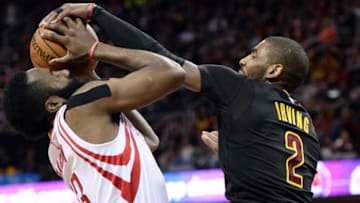 Mar 29, 2016; Cleveland, OH, USA; Cleveland Cavaliers guard Kyrie Irving (2) blocks and steals the ball from Houston Rockets guard James Harden (13) during the first quarter at Quicken Loans Arena. Mandatory Credit: Ken Blaze-USA TODAY Sports