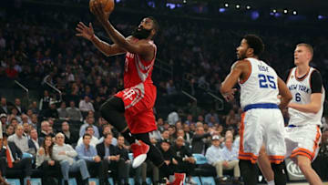 Nov 2, 2016; New York, NY, USA; Houston Rockets shooting guard James Harden (13) drives past New York Knicks point guard Derrick Rose (25) and New York Knicks power forward Kristaps Porzingis (6) during the first quarter at Madison Square Garden. Mandatory Credit: Brad Penner-USA TODAY Sports