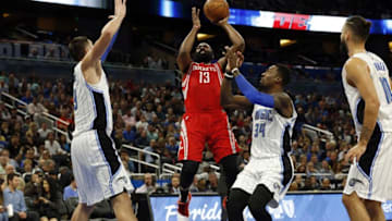 Jan 6, 2017; Orlando, FL, USA; Houston Rockets guard James Harden (13) shoots over Orlando Magic forward Jeff Green (34) and center Nikola Vucevic (9) during the second quarter at Amway Center. Mandatory Credit: Kim Klement-USA TODAY Sports