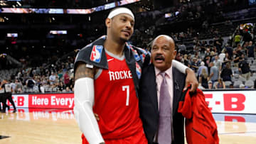 Carmelo Anthony #7 of the Houston Rockets walks off the court with assistant coach John Lucas (Photo by Edward A. Ornelas/Getty Images)