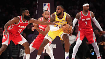 LeBron James #23 of the Los Angeles Lakers handles the ball against James Harden #13, Eric Gordon #10, and Carmelo Anthony #7 of the Houston Rockets (Photo by Harry How/Getty Images)