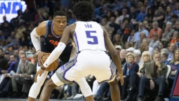 Russell Westbrook #0 of the Oklahoma City Thunder drives around De'Aaron Fox #5 of the Sacramento Kings (Photo by J Pat Carter/Getty Images)