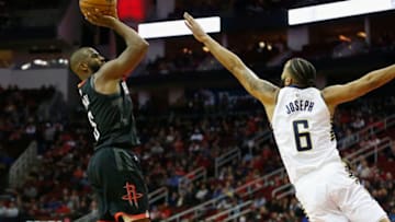 HOUSTON, TX - NOVEMBER 11: Chris Paul #3 of the Houston Rockets takes a jump shot defended by Cory Joseph #6 of the Indiana Pacers in the first half at Toyota Center on November 11, 2018 in Houston, Texas. NOTE TO USER: User expressly acknowledges and agrees that, by downloading and or using this Photograph, user is consenting to the terms and conditions of the Getty Images License Agreement. (Photo by Tim Warner/Getty Images)