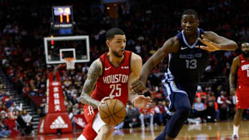 HOUSTON, TEXAS - DECEMBER 31: Austin Rivers #25 of the Houston Rockets drives past Jaren Jackson Jr. #13 of the Memphis Grizzlies during the second quarter at Toyota Center on December 31, 2018 in Houston, Texas. NOTE TO USER: User expressly acknowledges and agrees that, by downloading and or using this photograph, User is consenting to the terms and conditions of the Getty Images License Agreement. (Photo by Bob Levey/Getty Images)