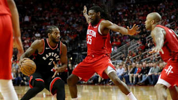 HOUSTON, TX - JANUARY 25: Kawhi Leonard #2 of the Toronto Raptors controls the ball defended by Kenneth Faried #35 of the Houston Rockets and PJ Tucker #17 in the second half at Toyota Center on January 25, 2019 in Houston, Texas. NOTE TO USER: User expressly acknowledges and agrees that, by downloading and or using this photograph, User is consenting to the terms and conditions of the Getty Images License Agreement. (Photo by Tim Warner/Getty Images)