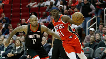 Jrue Holiday #11 of the New Orleans Pelicans drives around PJ Tucker #17 of the Houston Rockets