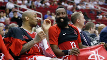HOUSTON, TEXAS - MARCH 28: PJ Tucker #17 of the Houston Rockets (L) and James Harden #13 share a laugh on the bench during a game against the Denver Nuggets at Toyota Center on March 28, 2019 in Houston, Texas. NOTE TO USER: User expressly acknowledges and agrees that, by downloading and or using this photograph, User is consenting to the terms and conditions of the Getty Images License Agreement. (Photo by Bob Levey/Getty Images)