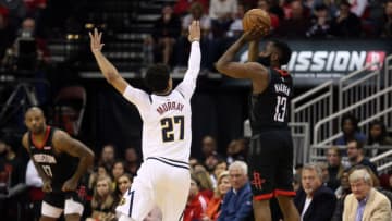 HOUSTON, TEXAS - DECEMBER 31: James Harden #13 of the Houston Rockets shoots a three point basket over Jamal Murray #27 of the Denver Nuggets during the fourth quarter at Toyota Center on December 31, 2019 in Houston, Texas. NOTE TO USER: User expressly acknowledges and agrees that, by downloading and/or using this photograph, user is consenting to the terms and conditions of the Getty Images License Agreement. (Photo by Bob Levey/Getty Images)