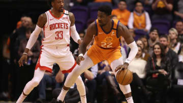 PHOENIX, ARIZONA - FEBRUARY 07: Deandre Ayton #22 of the Phoenix Suns handles the ball against Robert Covington #33 of the Houston Rockets during the first half of the NBA game at Talking Stick Resort Arena on February 07, 2020 in Phoenix, Arizona. NOTE TO USER: User expressly acknowledges and agrees that, by downloading and or using this photograph, user is consenting to the terms and conditions of the Getty Images License Agreement. Mandatory Copyright Notice: Copyright 2020 NBAE. (Photo by Christian Petersen/Getty Images)
