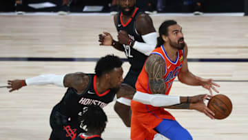 Steven Adams #12 of the Oklahoma City Thunder drives against Robert Covington #33 of the Houston Rockets (Photo by Kim Klement - Pool/Getty Images)