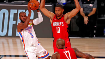 Chris Paul #3 of the Oklahoma City Thunder passes the ball against Eric Gordon#10 and P.J. Tucker #17 Houston Rockets (Photo by Kim Klement-Pool/Getty Images)