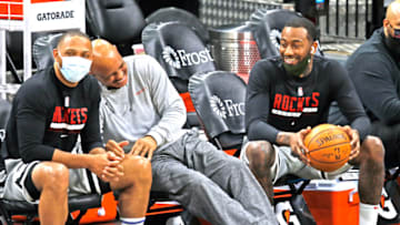SAN ANTONIO, TX - JANUARY 16: John Wall #1 of the Houston Rockets breaks up assistant coach John Lucas as talked with him and Eric Gordon #10 before the start of their game against the San Antonio Spurs at AT&T Center on January 16, 2021 in San Antonio, Texas. NOTE TO USER: User expressly acknowledges and agrees that , by downloading and or using this photograph, User is consenting to the terms and conditions of the Getty Images License Agreement. (Photo by Ronald Cortes/Getty Images)