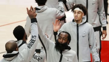 PORTLAND, OREGON - DECEMBER 26: James Harden #13 of the Houston Rockets high fives his teammates before the game against the Portland Trail Blazers at Moda Center on December 26, 2020 in Portland, Oregon. NOTE TO USER: User expressly acknowledges and agrees that, by downloading and/or using this photograph, user is consenting to the terms and conditions of the Getty Images License Agreement. (Photo by Steph Chambers/Getty Images)