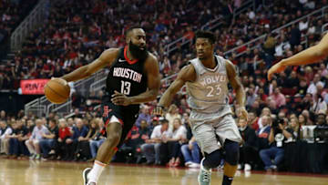 HOUSTON, TX - APRIL 15: James Harden #13 of the Houston Rockets drives to the basket against Jimmy Butler #23 of the Minnesota Timberwolves in the first half during Game One of the first round of the 2018 NBA Playoffs at Toyota Center on April 15, 2018 in Houston, Texas. NOTE TO USER: User expressly acknowledges and agrees that, by downloading and or using this photograph, User is consenting to the terms and conditions of the Getty Images License Agreement. (Photo by Tim Warner/Getty Images)