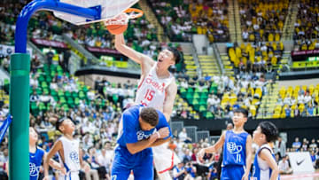 HONG KONG, HONG KONG - JULY 30: Zhou Qi of Chinese Men's Basketball Stars Team goes up for a dunk against American Professional Nike Rising Star Team during Yao Foundation Charity Tour match between American Professional Nike Rising Star Team and Chinese Men's Basketball Stars Team on July 30, 2017 in Hong Kong, Hong Kong. (Photo by Power Sport Images/Getty Images)