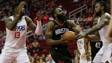 HOUSTON, TX - DECEMBER 22: James Harden #13 of the Houston Rockets drives to the basket defended by DeAndre Jordan #6 of the LA Clippers and Jamil Wilson #13 in the first half at Toyota Center on December 22, 2017 in Houston, Texas. NOTE TO USER: User expressly acknowledges and agrees that, by downloading and or using this Photograph, user is consenting to the terms and conditions of the Getty Images License Agreement. (Photo by Tim Warner/Getty Images)