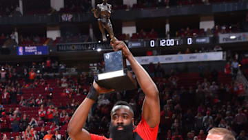 HOUSTON, TX - OCTOBER 17: James Harden #13 of the Houston Rockets is presented the Maurice Podoloff Trophy for MVP by Tilman Fertitta during a game on October 17, 2018 at Toyota Center, in Houston, Texas. NOTE TO USER: User expressly acknowledges and agrees that, by downloading and/or using this Photograph, user is consenting to the terms and conditions of the Getty Images License Agreement. Mandatory Copyright Notice: Copyright 2018 NBAE (Photo by Bill Baptist/NBAE via Getty Images)