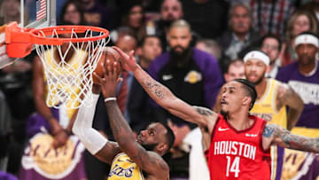 LeBron James #23 of the Los Angeles Lakers goes for a layup against Gerald Green #14 of the Houston Rockets (Photo by Yong Teck Lim/Getty Images)