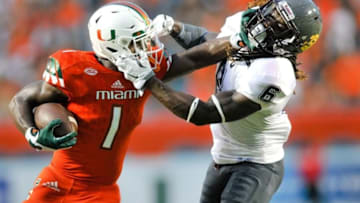 Sep 5, 2015; Miami Gardens, FL, USA; Miami Hurricanes defensive back Artie Burns (1) stiff arm Bethune Cookman Wildcats defensive back Marquis Drayton (6) during the first half at Sun Life Stadium. Mandatory Credit: Steve Mitchell-USA TODAY Sports