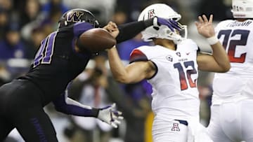 Oct 31, 2015; Seattle, WA, USA; Washington Huskies linebacker Travis Feeney (41) knocks the ball loose from Arizona Wildcats quarterback Anu Solomon (12) during the third quarter at Husky Stadium. Arizona would recover. Mandatory Credit: Jennifer Buchanan-USA TODAY Sports