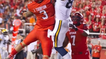 Sep 3, 2015; Salt Lake City, UT, USA; Michigan Wolverines tight end Jake Butt (88) catches a touchdown pass over Utah Utes defensive backs Jason Thompson (3) and Andre Godfrey (7) during the second half at Rice-Eccles Stadium. Utah won 24-17. Mandatory Credit: Russ Isabella-USA TODAY Sports