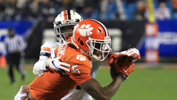 CHARLOTTE, NORTH CAROLINA - DECEMBER 07: Tee Higgins #5 of the Clemson Tigers makes a catch against Nick Grant #1 of the Virginia Cavaliers during the ACC Football Championship game at Bank of America Stadium on December 07, 2019 in Charlotte, North Carolina. (Photo by Streeter Lecka/Getty Images)