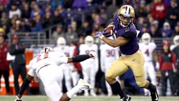 SEATTLE, WA - NOVEMBER 03: Myles Gaskin #9 of the Washington Huskies breaks a tackle against Paulson Adebo #11 of the Stanford Cardinal in the first quarter during their game at Husky Stadium on November 3, 2018 in Seattle, Washington. (Photo by Abbie Parr/Getty Images)