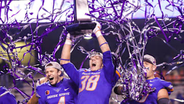 BOISE, ID - DECEMBER 2: Linebacker Leighton Vander Esch #38 and quarterback Brett Rypien #4 of the Boise State Broncos hoist the championship trophy at the conclusion of the Mountain West Championship game against the Fresno State Bulldogs on December 2, 2017 at Albertsons Stadium in Boise, Idaho. Boise State won the game 17-14. (Photo by Loren Orr/Getty Images)