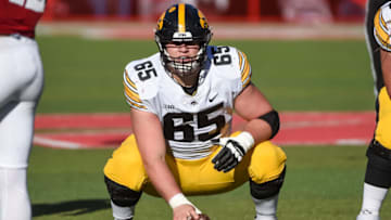 LINCOLN, NE - NOVEMBER 26: Offensive lineman Tyler Linderbaum #65 of the Iowa Hawkeyes prepares to snap the ball against the Nebraska Cornhuskers in the first half at Memorial Stadium on November 26, 2021 in Lincoln, Nebraska. (Photo by Steven Branscombe/Getty Images)