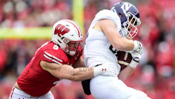 Marshall Lang #88 of the Northwestern Wildcats is tackled by Leo Chenal #5 of the Wisconsin Badgers. (Photo by Patrick McDermott/Getty Images)