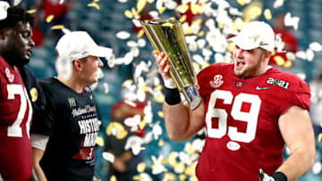 Jan 11, 2021; Miami Gardens, Florida, USA; Alabama Crimson Tide offensive lineman Landon Dickerson (69) celebrates with the CFP National Championship trophy after beating the Ohio State Buckeyes in the 2021 College Football Playoff National Championship Game. Mandatory Credit: Mark J. Rebilas-USA TODAY Sports